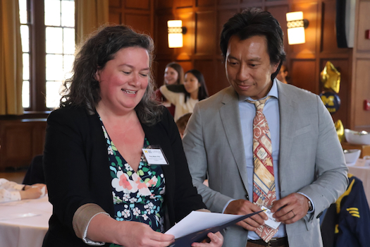 A nominee for a WISE award and her husband look over a program together at the Willie Hobbs Moore Awards Ceremony.